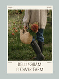 bellingham Flower Farm Gift Card. A vertical poster-style graphic with a photo of a person in an apple orchard holding a